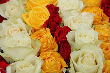 Image showing yellow, white and red roses in a wedding arrangement