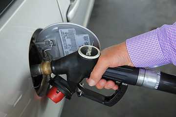 Image showing Pumping gas at a gas station