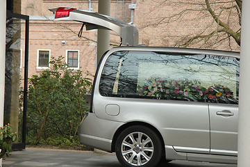 Image showing Grey hearse with sympathy flowers