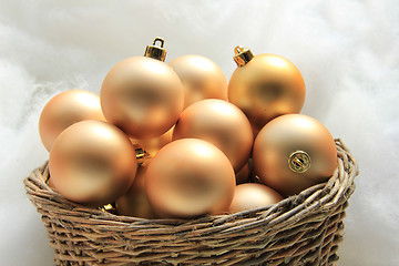 Image showing Golden Christmas ornaments in a wicker basket