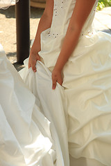 Image showing Bridesmaid helping the bride