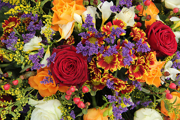 Image showing Mixed floral arrangement in yellow, red and white