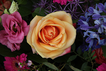 Image showing Orange pink rose in a mixed bouquet
