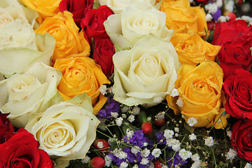 Image showing yellow, white and red roses in a wedding arrangement
