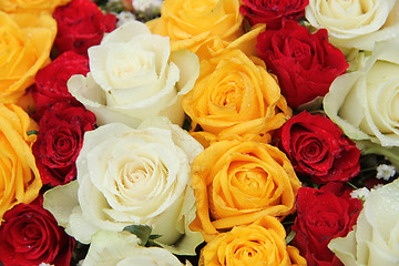 Image showing yellow, white and red roses in a wedding arrangement