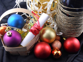 Image showing bottle of champagne, christmas balls and white invitation paper