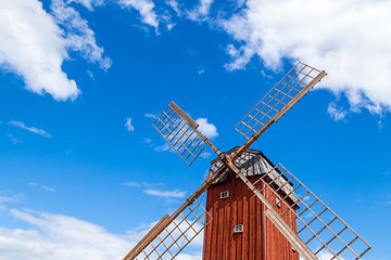 Image showing Wooden windmill under blue sky