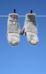 Image showing Mittens hanging to dry – the winter is over