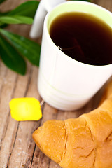 Image showing cup of tea and fresh croissant