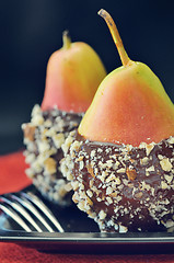 Image showing two fresh pear with chocolate icing 