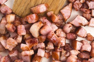 Image showing Macro photo of bacon being fried in a pan