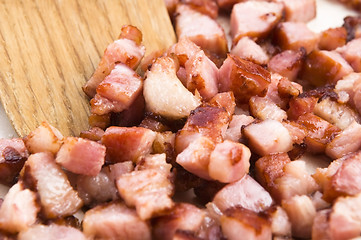 Image showing Macro photo of bacon being fried in a pan