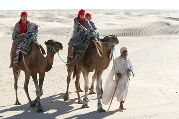 Image showing Beduin leading tourists on camels