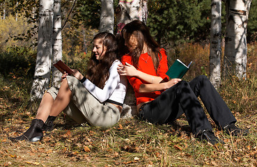 Image showing Girls reading  in the park