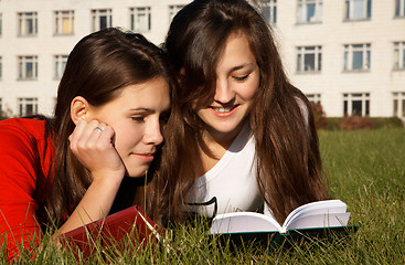 Image showing Girls reading the books on the lawn