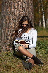 Image showing Girl reading the book in the park