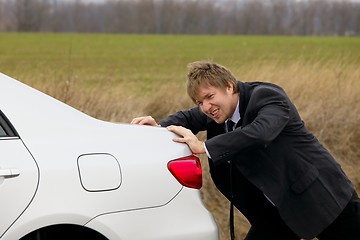 Image showing Pushing car