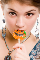 Image showing Girl sucking the sugar pumpkin