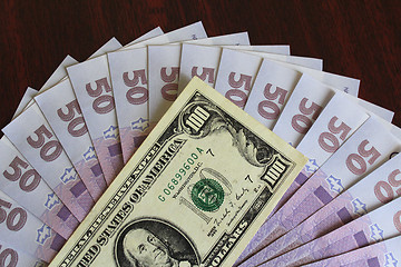 Image showing dollar and grivnas banknotes on dark background