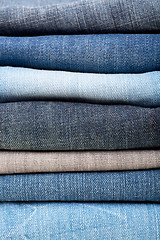 Image showing stack of blue jeans background