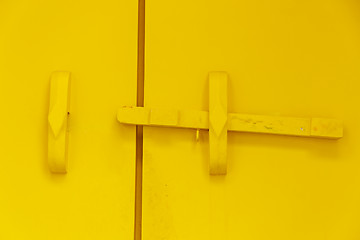 Image showing Yellow wooden door bar