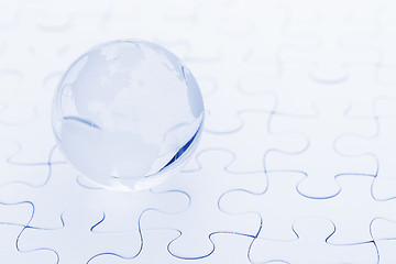 Image showing Glass globe ball on puzzle