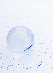 Image showing Crystal glass globe ball on puzzle