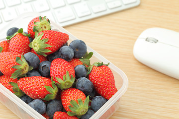 Image showing Berry mix lunch box in working desk