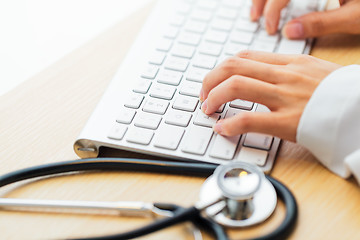 Image showing Doctor typing keyboard with stethoscope