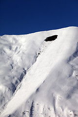 Image showing Trace of avalanche on off piste slope in sun day