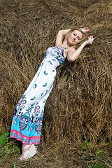 Image showing Young beautiful woman on hay