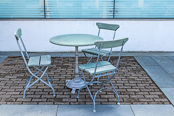 Image showing Table and three chairs in an outdoor cafe