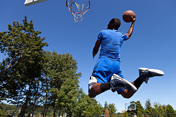 Image showing Man Dunking a Basketball