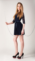 Image showing beautiful fashionable woman near chain swing