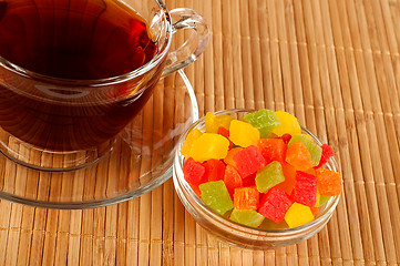 Image showing Cup of tea with candied fruits