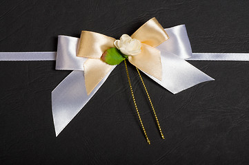 Image showing White bow with a flower.