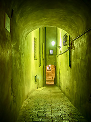 Image showing Narrow illuminated alley