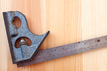 Image showing Closeup of metal set square on wood