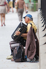 Image showing PARIS, FRANCE - JULY 27, 2013: An accordion player sitting on a 