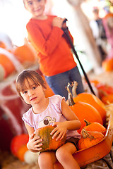 Image showing Cute Girl Riding Wagon with Her Pumpkin and Sister