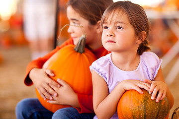 Image showing Cute Little Girls Holding Their Pumpkins At A Pumpkin Patch