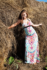 Image showing Young beautiful woman on hay