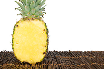 Image showing Sliced pineapple on wooden table