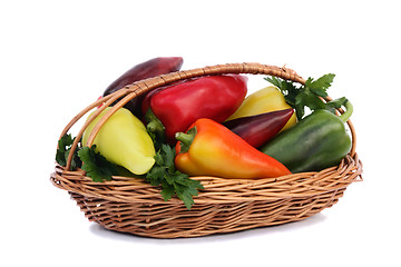 Image showing Red, yellow and green pepper in a basket on a white background.