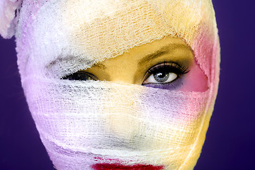 Image showing Extreme Beauty Concept of Heavy Makeup Seeping Through Gauze