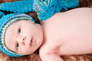 Image showing Newborn baby in blue knitted hat