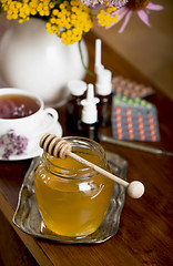 Image showing Still life from medicinal herbs, honey, herbal tea and medicines