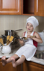 Image showing girl in a cap and an apron