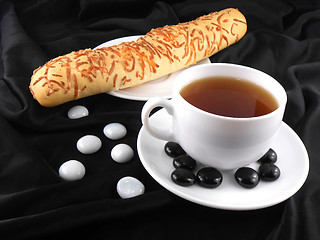 Image showing Hot coffee with bread and stones on black background