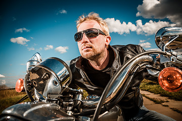 Image showing Biker racing on the road